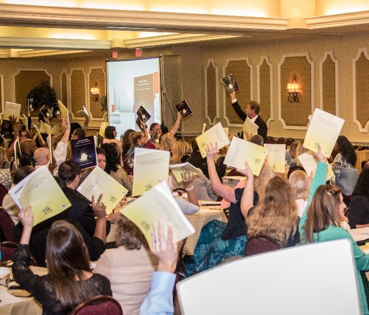 Teachers holding their Resource Manuals